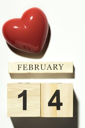 14 February valentine day Red heart shaped with wooden cube calendar with shadow on white background, Flat layの写真素材