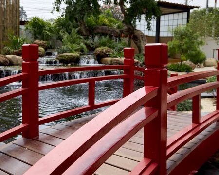 Japan with small inside indoor garden Japanese traditional garden, red bridge with gravel stone rocks and lantern lamp at home or houseの写真素材