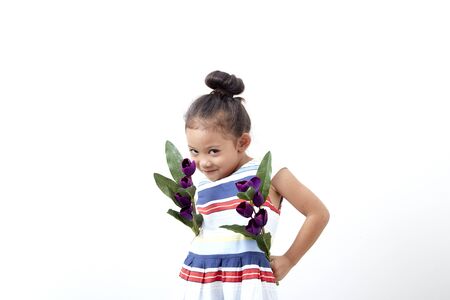 Portrait Happy funny asian cute child girl easter day hand holding  bouquet purple tulip on white background . Happy easterの写真素材