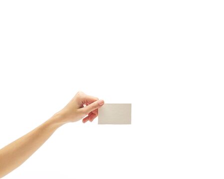 asian female hand holds white empty paper card on a white background.の写真素材