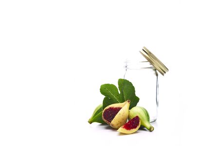 Ripe figs and Empty glass bottle on white background, Vegetarian food conceptの写真素材