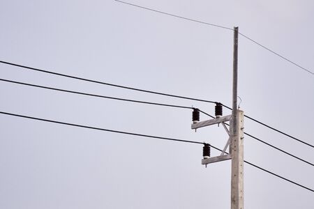 Electricity cable wire and cement pole with clear sky background
