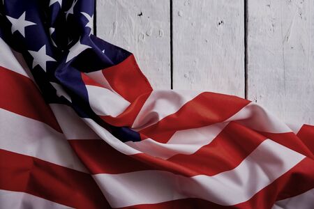 American Flag for the America's 4th of July Celebration over a white wooden rustic background to mark America's Independence Day. Image shot from top view.の写真素材