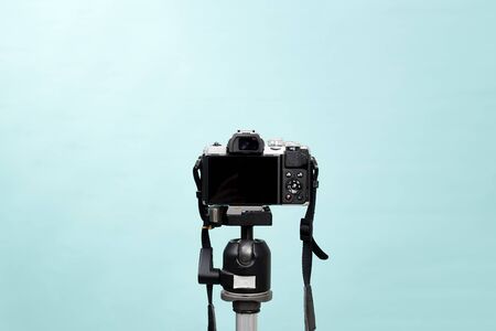 Back side of a mirrorless camera on a tripod the pastel blue scene of the studio