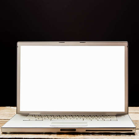 Computer mockup wall black background on table. Laptop with blank screen.