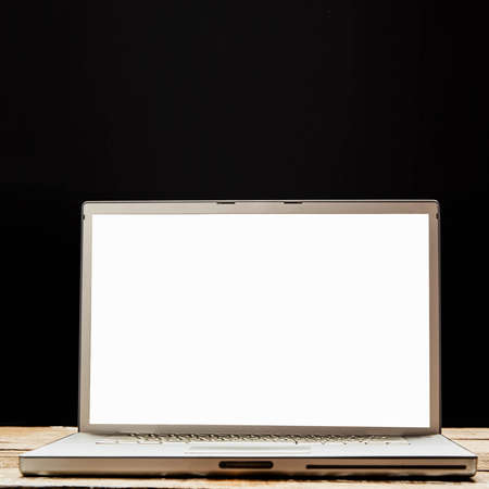 Computer mockup wall black background on table. Laptop with blank screen.の写真素材