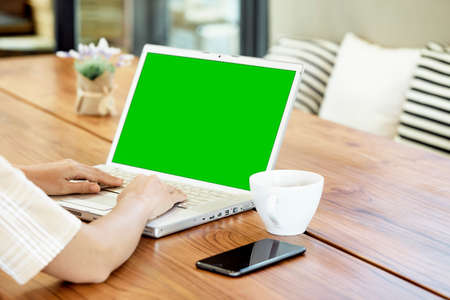 Close-up asian women are using laptops to work at home, online working, video call due to social...