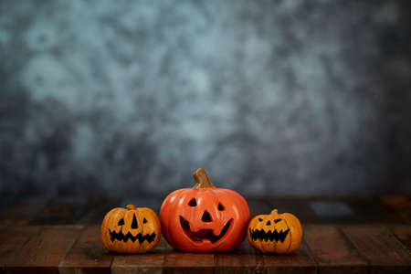 Halloween pumpkin head jack lantern on wooden table dark background. concept holiday halloweenの写真素材
