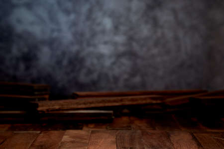 Empty wood table top counter on dark wall background.For create product display or design key visualの写真素材