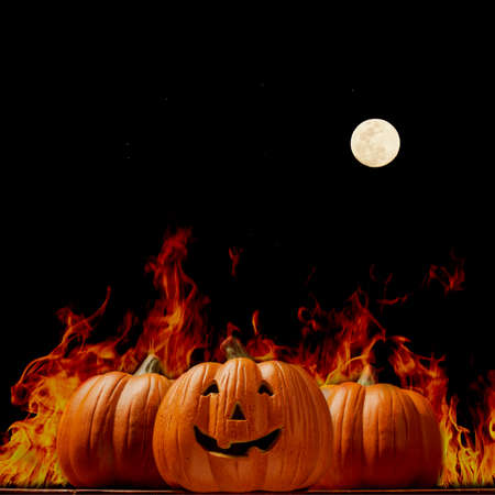 Halloween Pumpkin on wooden table in front of spooky dark background