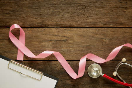 Pink ribbon on wooden background. breast cancer awareness background concept. copy space for textの写真素材