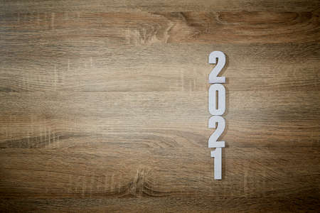 wooden white numbers 2021 on Wooden desk background. change year 2020 to 2021