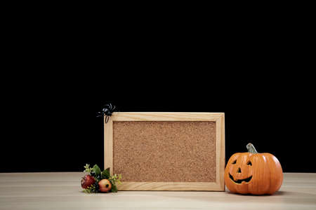 Frame and Jack O Lantern Halloween festival decoration pumpkin with witches hat on wooden table with...