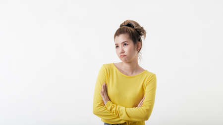 Attractive happy confident thai woman standing with arms folded and looking at camera