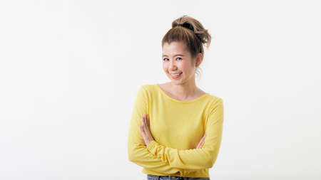 Attractive happy confident thai woman standing with arms folded and looking at camera