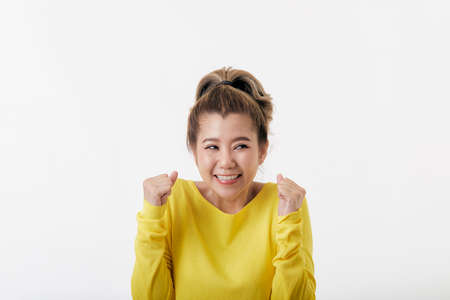 Portrait beautiful Young happy Asian women happy and surprisedshe wearing yellow sweater shirt shoot...