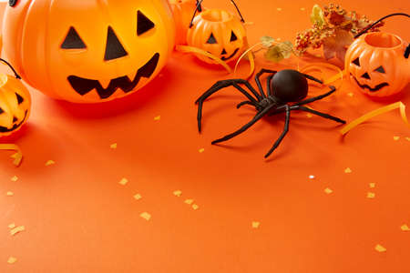 Funny Halloween day decoration party cute pumpkin ghost and  spider isolated on orange backgroundの写真素材