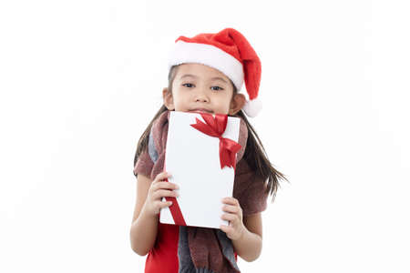Asian Child holding Christmas gift box in hand Isolated on white backgroundの写真素材