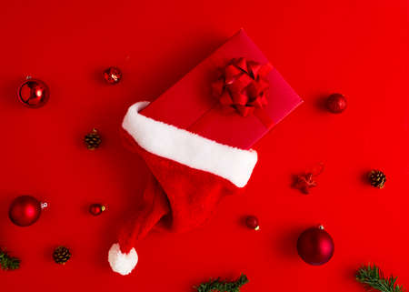 2020 New Year Christmas presents Santa hat with gifts and Christmas decorations on a red paper...