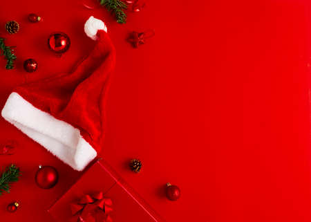 2020 New Year Christmas presents Santa hat with gifts and Christmas decorations on a red paper...