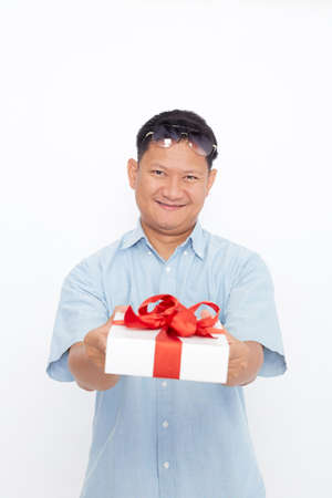 Portrait of Handsome Asian man holding gift box on white backgroundの写真素材