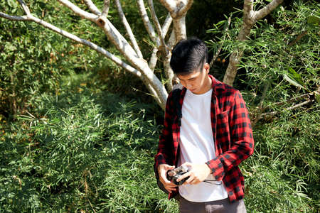 Young hipster Asian man traveling with a backpack in summer forest trip travel lifestyle conceptの写真素材