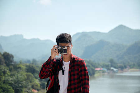 Young hipster Asian man traveling with a backpack in summer forest trip travel lifestyle conceptの写真素材