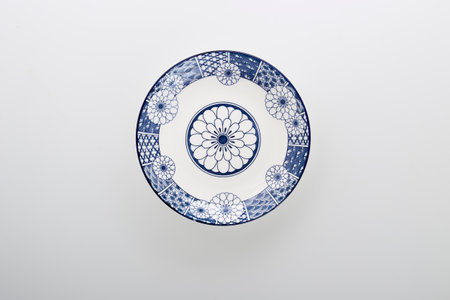 Ceramics decorative plates Blue and white pottery plate isolated on white backgroundの写真素材