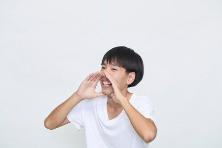 Attractive young man shouting Announcement on white background with copy space for text