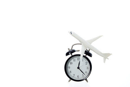 Clock with plane isolated on white background, Travel concept