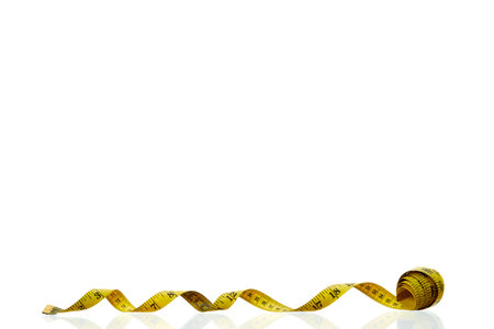 Yellow measuring tape isolated on white backgroundの写真素材