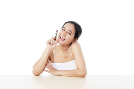Beautiful woman with lipstick on white. Beautiful Young Asian Woman with Clean Fresh Skin. Face care, Facial treatment, Cosmetology, beauty, and healthy skin and cosmetic ideas conceptの写真素材
