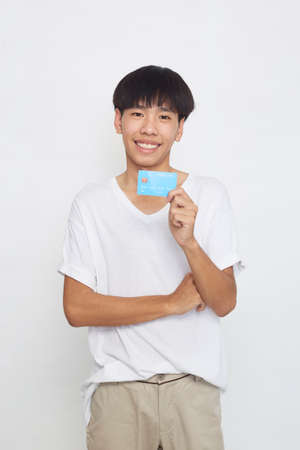 Asian man showing credit card payment concept isolated on white background