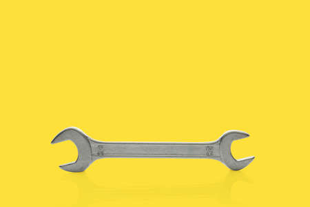 Wrench isolated on yellow background. Top view. Clipping pathの写真素材
