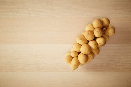Top view Group of Longkong is fruit southern Asian Thai on the wooden table copy space for textの写真素材