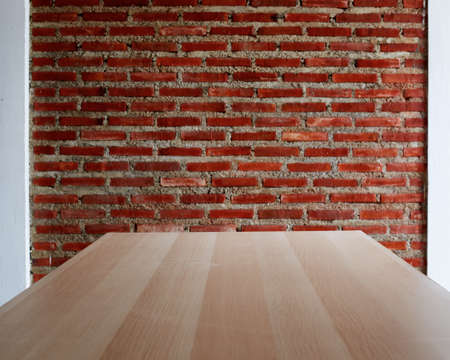 Wooden board empty table with a background of Red Bricks wallの写真素材