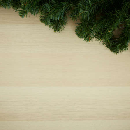 Overhead Christmas pine leaves empty space decoration on wooden background with copy spaceの写真素材