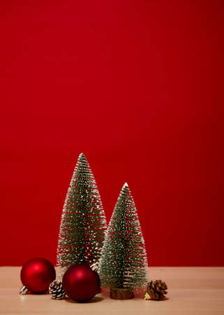 Christmas tree composition gift box Christmas baubles on a wooden table wall red background. for new year or Merry christmas holidays of free space for your decoration Copy space for your textの写真素材