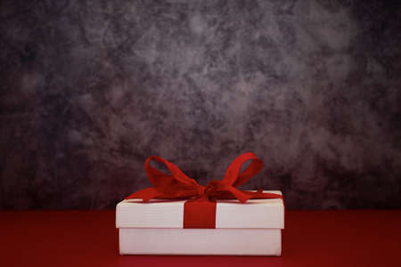 Composition with Christmas gift box decoration on red backgroundの写真素材