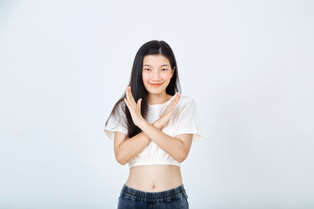 Beautiful young Asian woman Break the bias symbol of woman's international day. Crossed handsの写真素材
