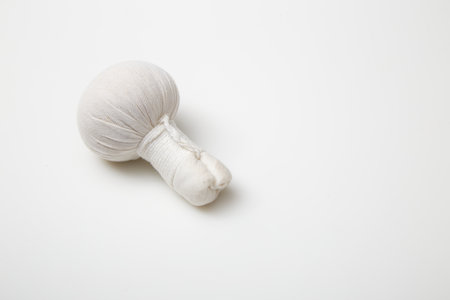 Herbal compress balls for Thai massage and spa treatment on white background. Copy spaceの写真素材