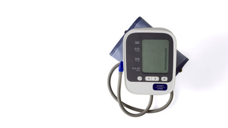 Upper arm digital blood pressure monitor at home with automatic system isolated white background.の写真素材