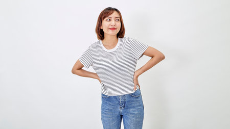 Attractive Asian woman in a casual t-shirt and blue jeans with action person white background. Copy spaceの写真素材