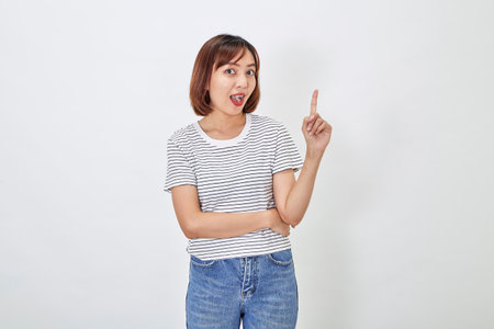 Attractive Asian woman in a casual t-shirt and blue jeans with action person white background. Copy spaceの写真素材