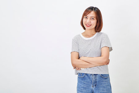 Attractive Asian woman in a casual t-shirt and blue jeans with action person white background. Copy spaceの写真素材