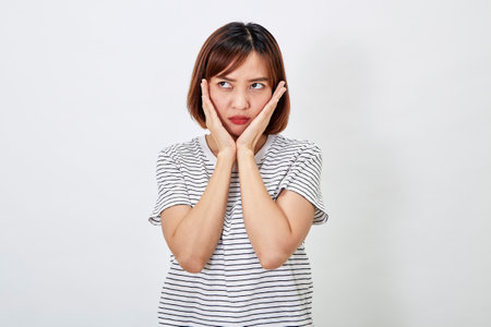 Attractive Asian woman in a casual t-shirt and blue jeans with action person white background. Copy spaceの写真素材