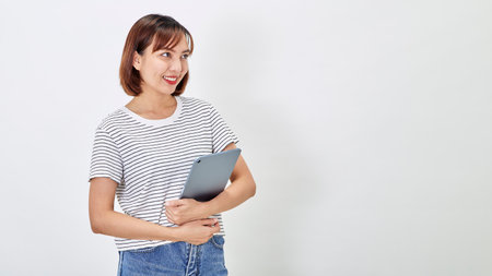 Young asian woman using tablet computer on white backgroundの写真素材