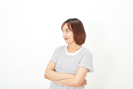Charming young Asian businesswoman with a short brunette wearing a t-shirt and jeans standing on a white background copy spaceの写真素材