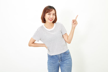 Charming young Asian businesswoman with a short brunette wearing a t-shirt and jeans standing on a white background copy spaceの写真素材