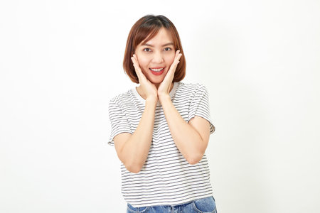 Charming young Asian businesswoman with a short brunette wearing a t-shirt and jeans standing on a white background copy spaceの写真素材